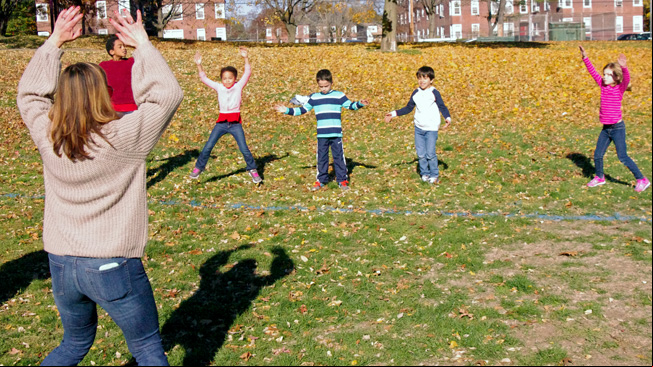 Kids and parent do jumping
jacks